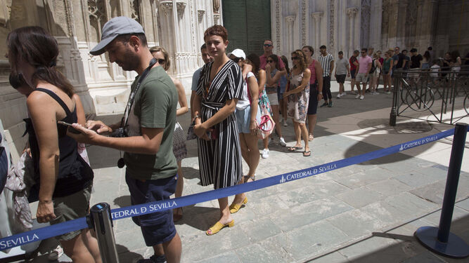 Un grupo de turistas hacen cola para acceder a la Catedral.